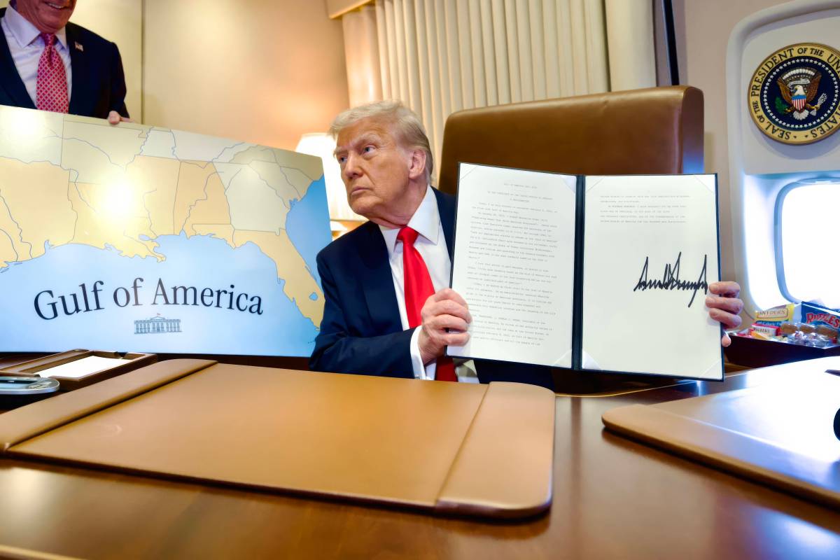 U.S. President Donald Trump, holds up the signed executive order renaming the Gulf of Mexico as the Gulf of America, during a flight on Air Force One to attend the Super Bowl,